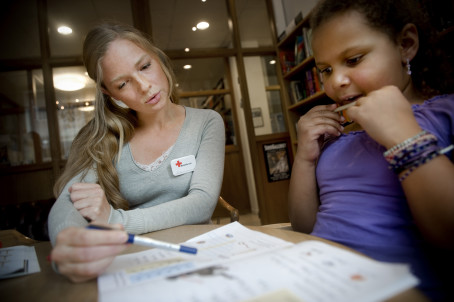 Frivilliga från Röda Korsets Ungdomsförbund hjälper till med läxorna